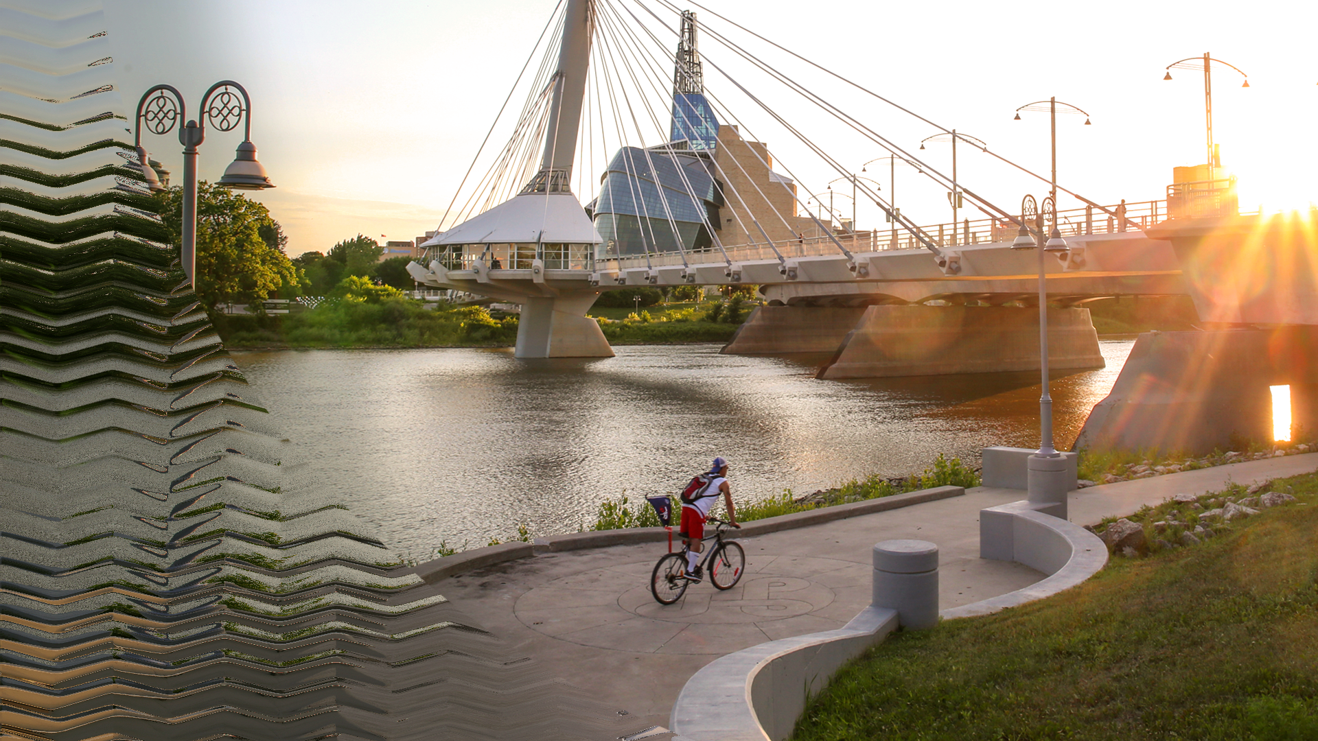 Provencher Bridge in Winnipeg with a man biking.