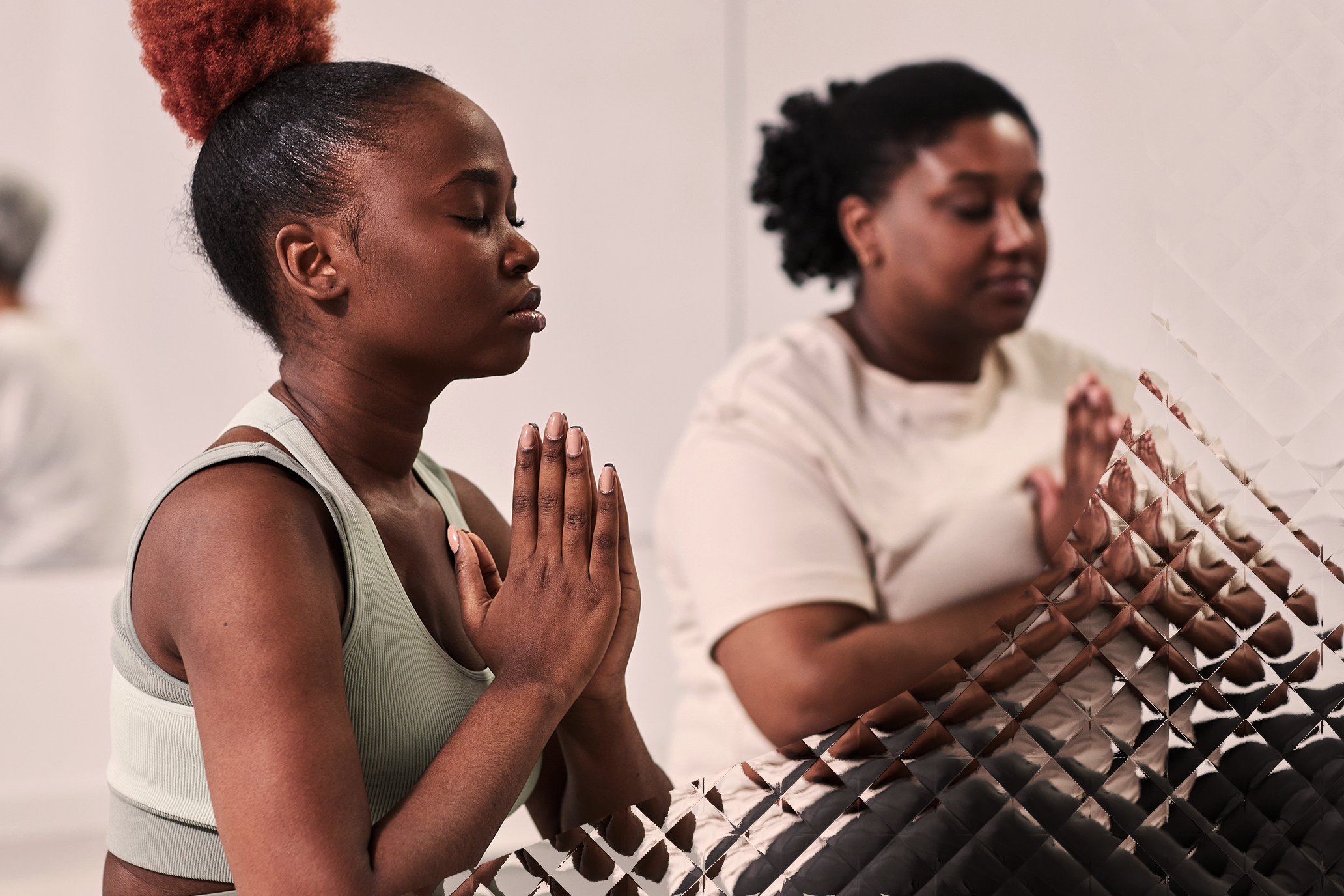 Two ladies meditating during yoga.