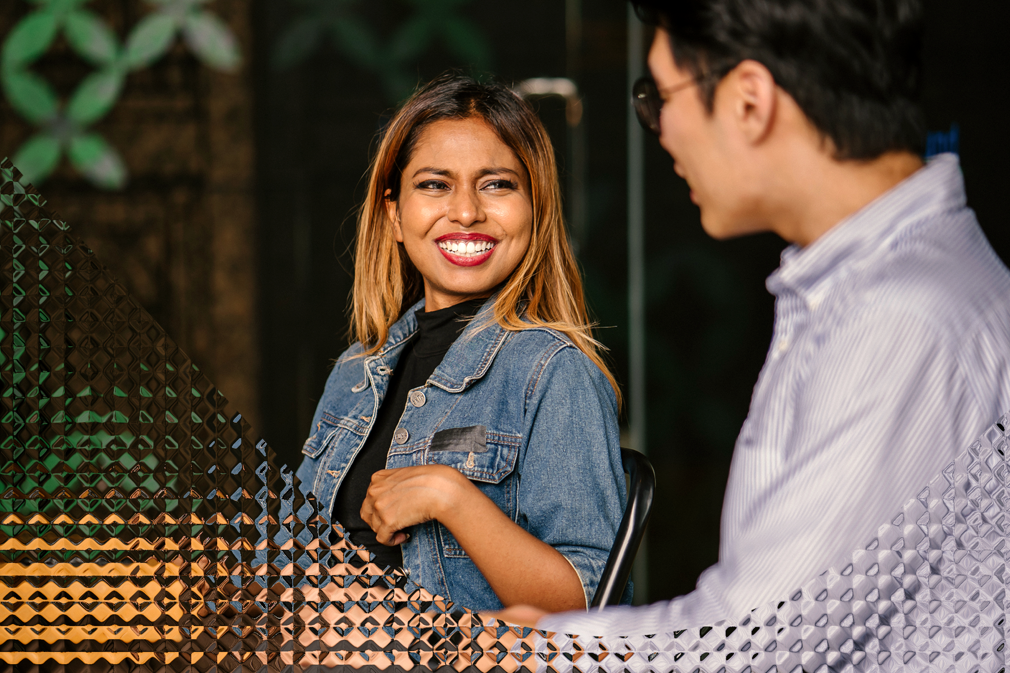 Smiling woman talking to a co-worker.